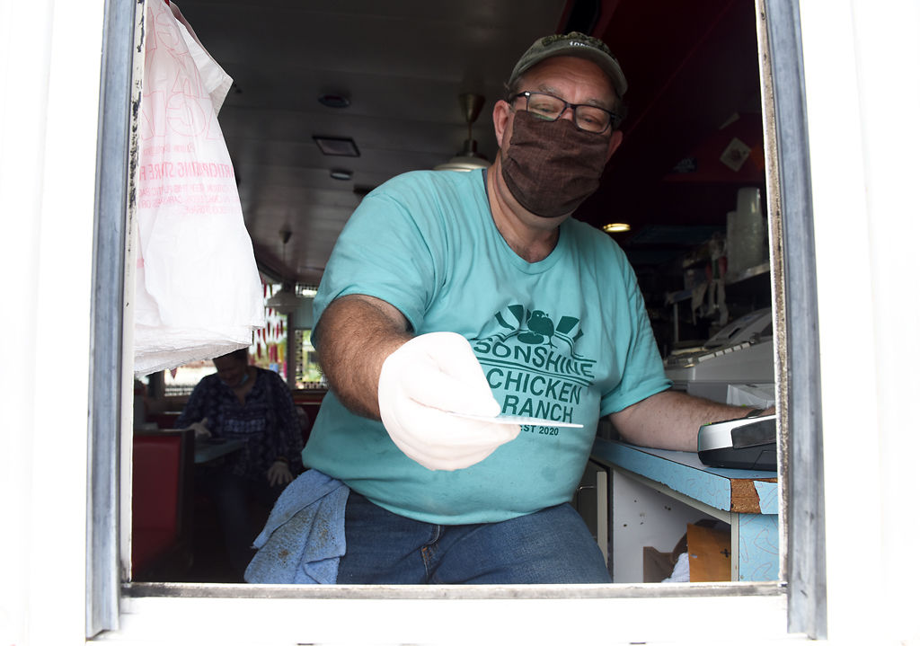 Broadway Diner owner Dave Johnson returns a credit card from the pick-up window